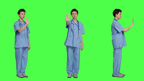 Health-specialist-with-blue-scrubs-showing-stop-sign-in-studio